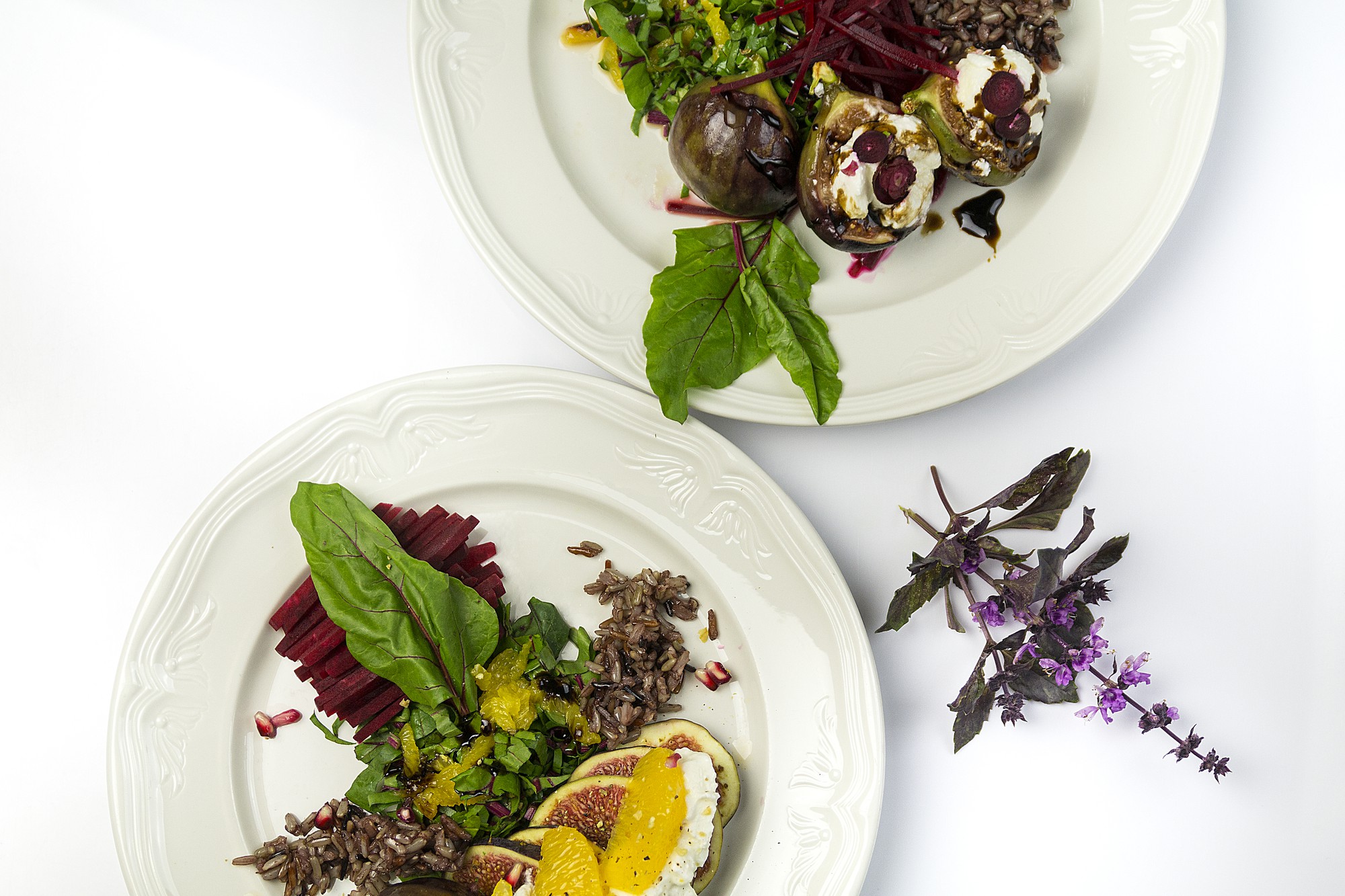 Close-up of plated tasting menu with herbs