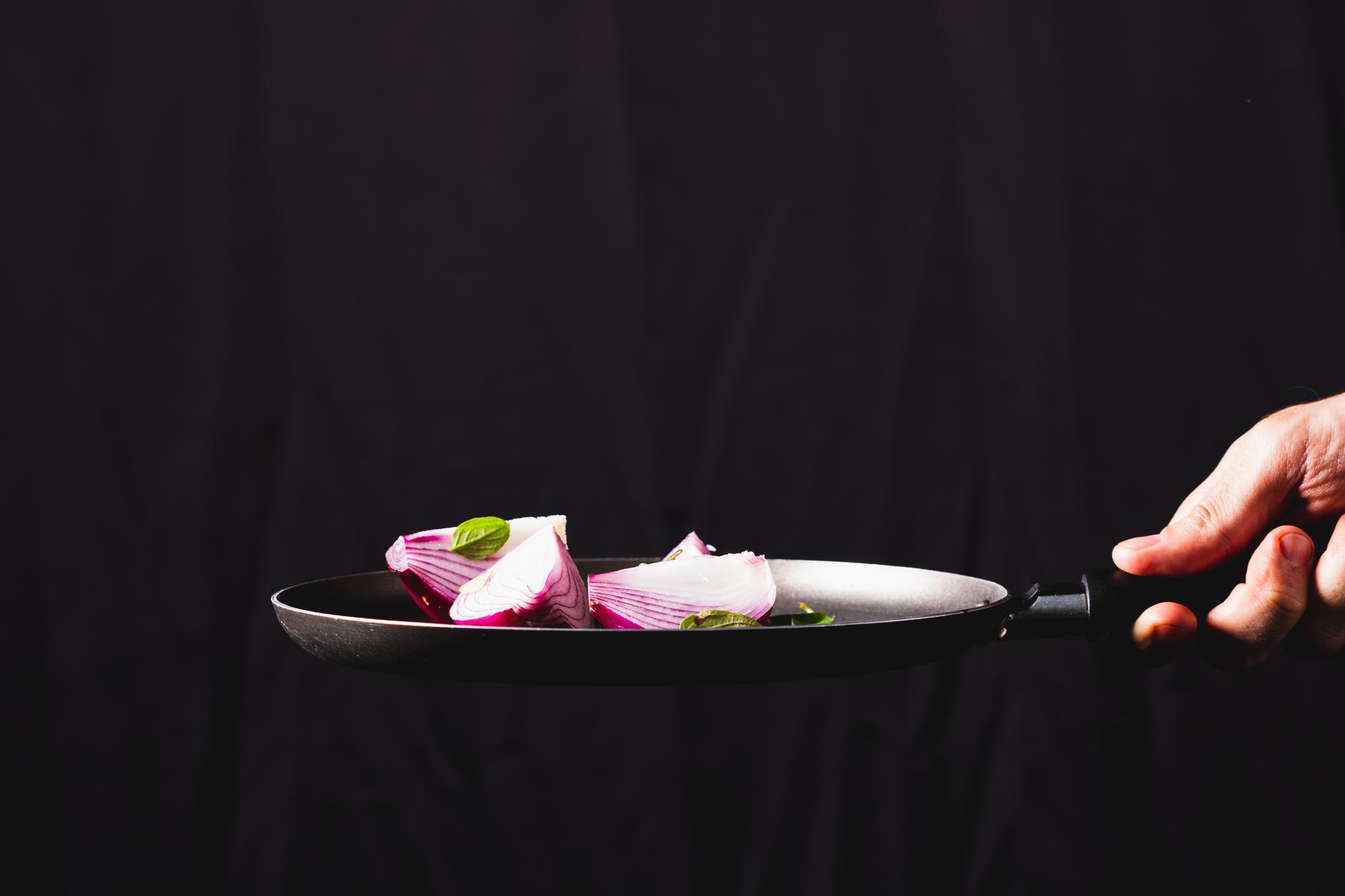 Chef plating a modern dish on slate